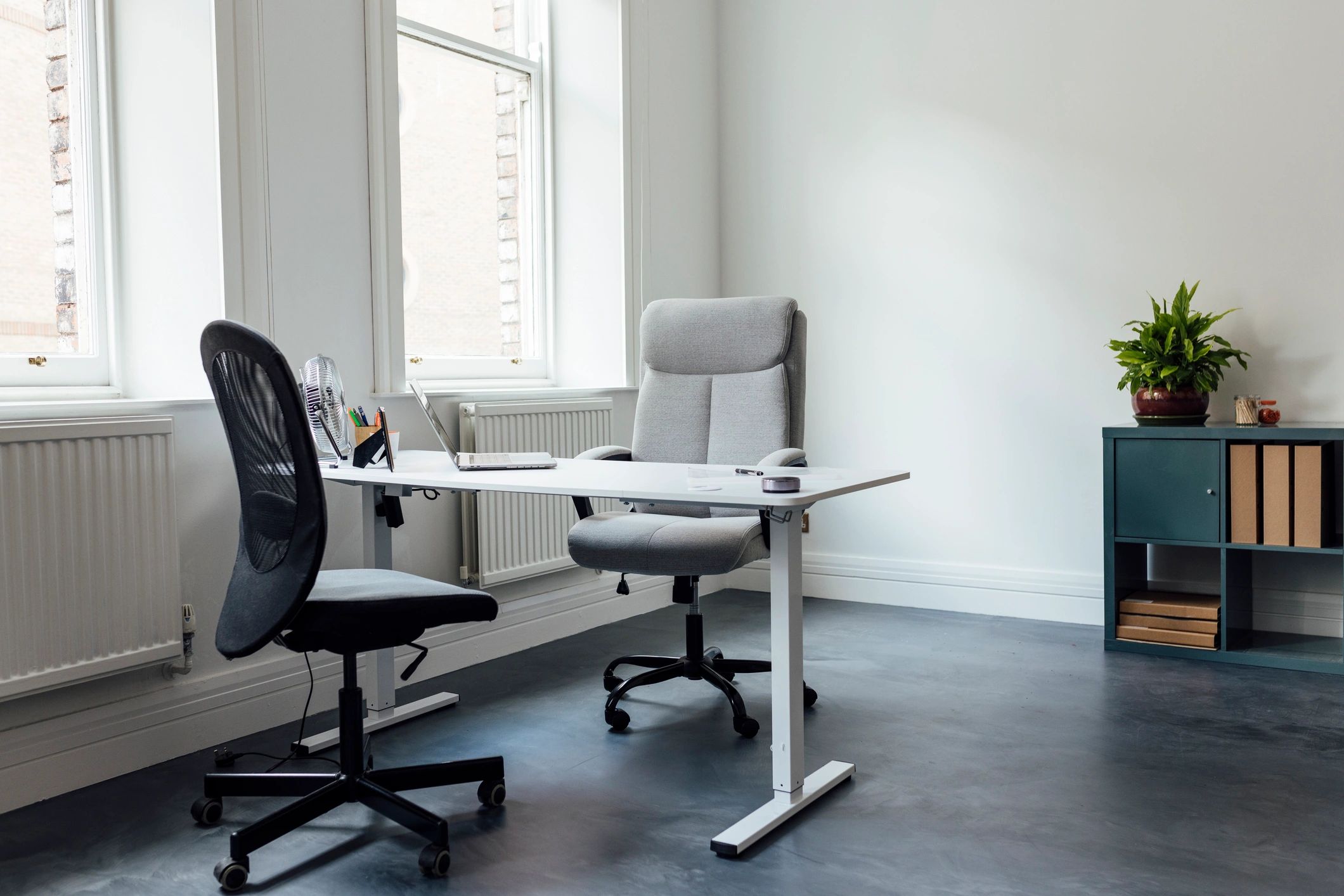 Minimal studio office with desk and chairs